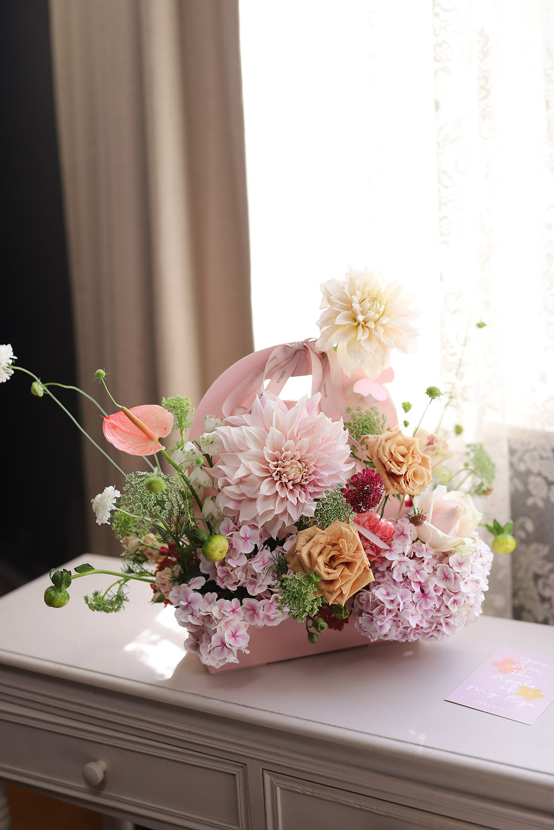 pink flower arrangement in a pink box